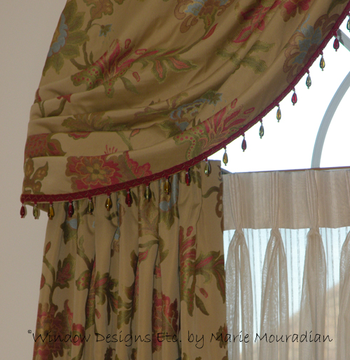 The glass beads on the swag shimmer in the light of this Arched window treatment on an arch top window. See more at www.windowdesignsetc.com by Marie Mouradian