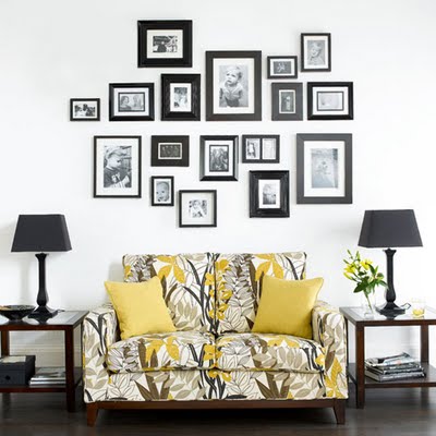 Black Framed Photos Over Black and Gold Sofa. Black and gold interiors. see more on www.windowdesignsetc.com by Marie Mouradian