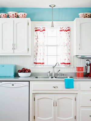 0's white kitchen with aqua blue walls and red and white curtains. 4th of July red, white and blue