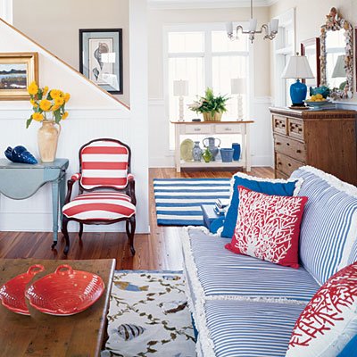 4th of July red, white and blue beach house. Blue and white sofa with red pillows.