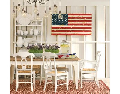 4th of July red, white and blue. Wooden flag on wall in white dining room