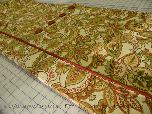 Tangerine Tango Asymmetric Valance on the worktable and ready to be installed. Gold, green, rust. See more at www.windowdesignsetc.com by Marie Mouradian