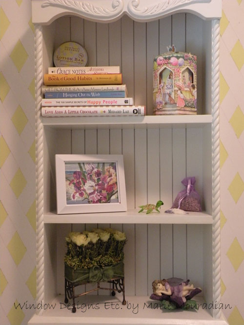 Summer shelf styling in powder room.  Beach, flowers, books in designer home.