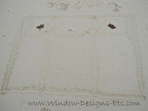 Window treatment drawing in the sand with seaweed and shells. Interior Design inspiration at the beach for a Cape Cod home. See more at www.windowdesignsetc.com by Marie Mouradian
