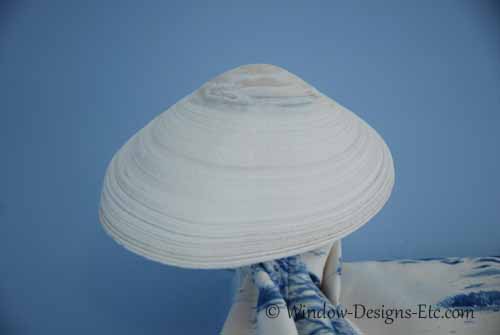 Detail of Clam shell being used as a holdup for window treatments for beach house bedroom. See more at www.WindowDesignsEtc.com
