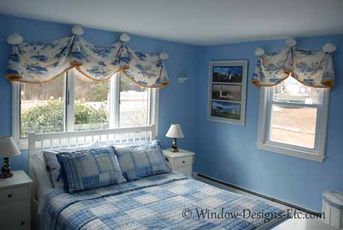 Wide views of cape cod blue bedroom window treatments for beach house. Large clam shells and blue lighthouse fabric on valances. See more at www.WindowDesignsEtc.com