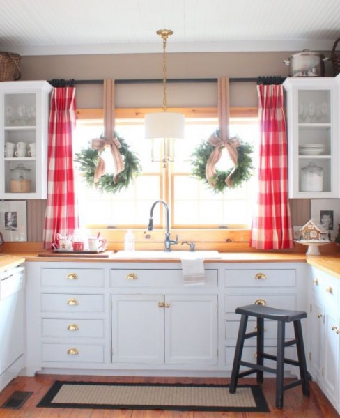 Holiday window ideas. Two wreaths hung with jute webbing at a kitchen sink with red buffalo check curtains. More beautiful windows decorated for Christmas here http://demo2.coolhatwebdesign.com/
