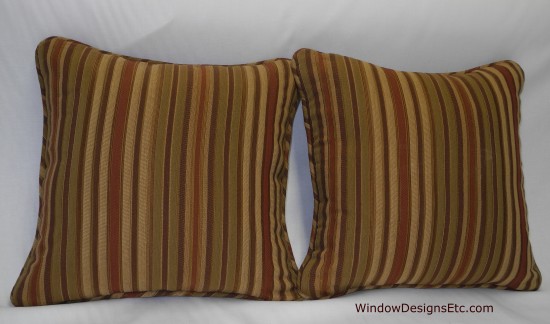 Custom decorative stripe pillows by Marie Mouradian. Brown, rust and green stripe with welt. Contact WindowDesignsEtc.com for further information