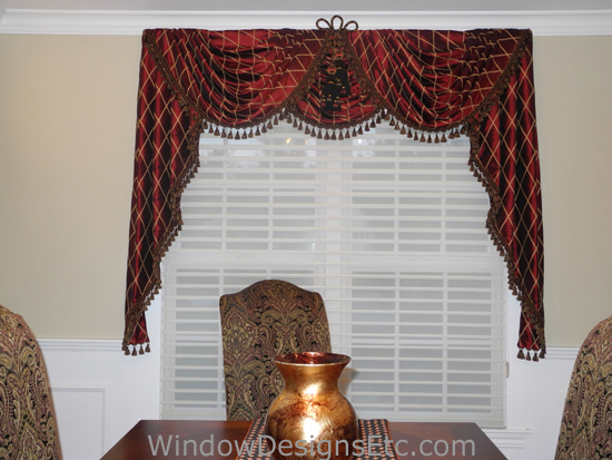 Red at Home. Red and gold elaborate and formal swags and cascades on a double window. Tassel trim finished the edges and center tassels and loop complete the center. Designed and Created by Window Designs Etc. By Marie Mouradian