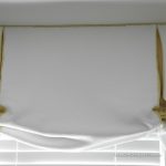 Detail of valance is a variation of a balloon and relaxed Roman shade in white matelasse with contrasting yellow in the pleats.