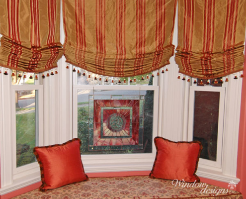 Roman shades are relaxed, hobbled, slatted or flat fold. Bay window seat with relaxed Roman shades Worcester, MA